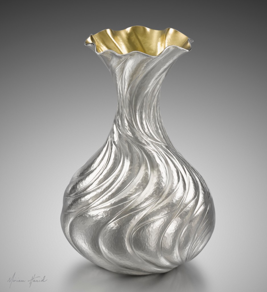 'Cascade Bud Vase' designed to hold just one or two flowers. Hand chased in fine silver, with a lemon gilt interior.