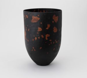 A deep rounded Wood vessel in earthy tones of brown and patches of terractotta colourr by Park Hong-gu, represented by Han Collection